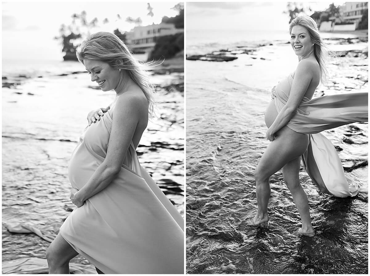 Black and white maternity photos for Beach maternity shoot wearing gown with long train thrown in the wind