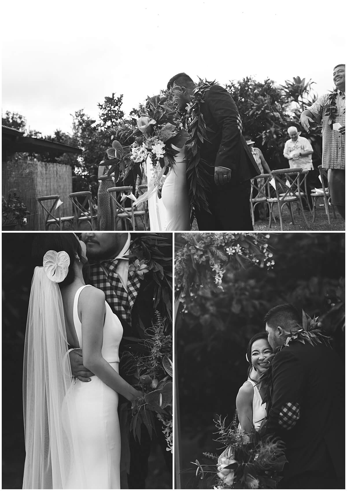 groom holding bride around waist under greenery by wedding photographer in oahu